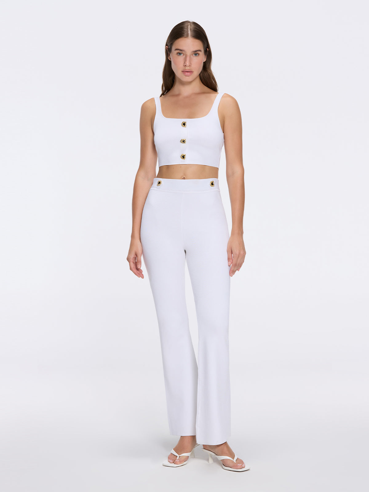 Aureline White Knitted Scoop Neck Gold Buttoned Crop Top | Moeva | Crop Top | Each week unveils new pieces—luxury swimwear, fluid resort silhouettes, and elevated summer-to-evening essentials designed to carry you from coastal escapes to city nights.